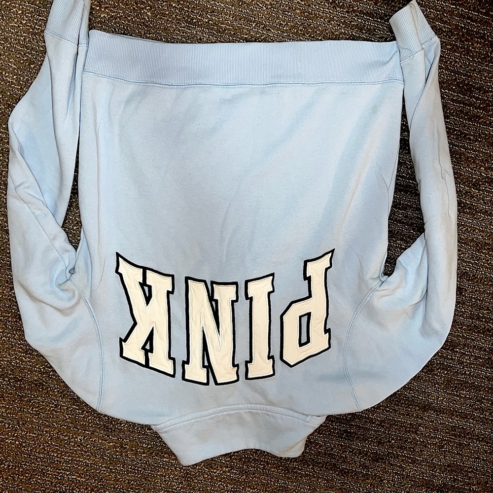 Pink pull over sweatshirt with zipper. Light blue in colour